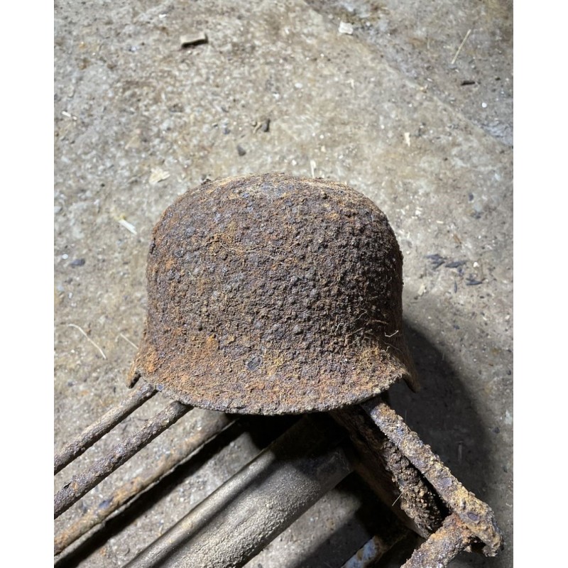 Early M35 helmet with remnants of a camouflage cover