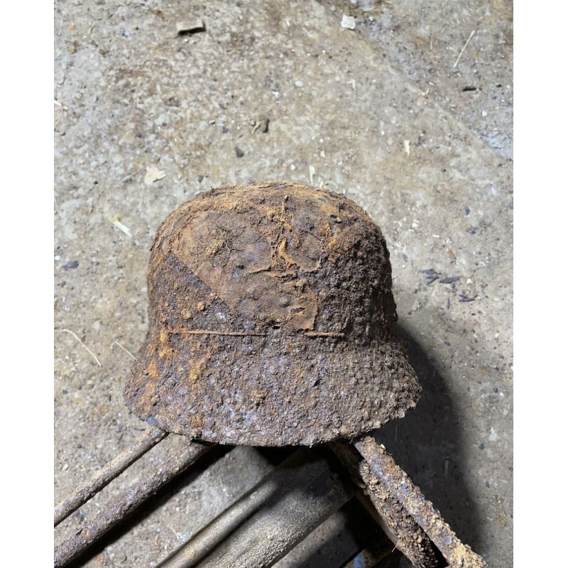 Early M35 helmet with remnants of a camouflage cover