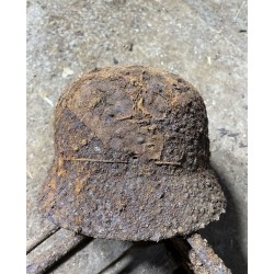 Early M35 helmet with remnants of a camouflage cover