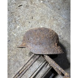 Early M35 helmet with remnants of a camouflage cover