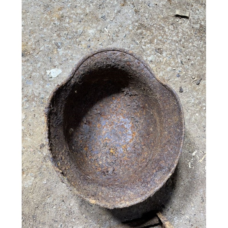 Early M35 helmet with remnants of a camouflage cover