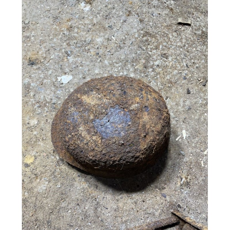 Early M35 helmet with remnants of a camouflage cover